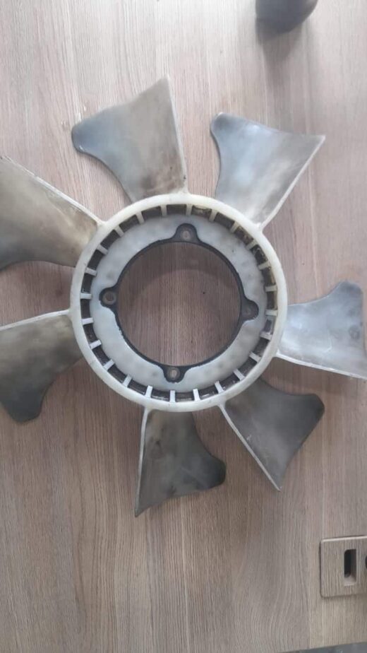 Radiator Fan Blade Used radiator fan blade shown from top angle with visible mounting hub and blades.Used radiator fan blade show