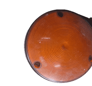 Front-facing view of a new trailer indicator light with a clear orange lens and black housing.Front-facing vie