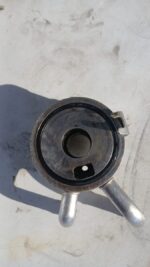 Front angle view of a clean, used oil cooler for 1995 Honda Ballade/Civic, showing cooling fins and inlet/outl