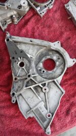 Close-up front angle of a grey automotive timing belt cover for a Hyundai H100, showing mounting holes and ope