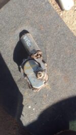 Rear view of a used rear wiper motor for a Mercedes Vito, showing mounting points and mechanical components.Re