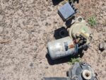 Used Datsun wiper motor shown from side angle highlighting electrical connectors and mounting points.Used Dats