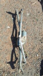 Front view of a used Audi A4 wiper motor showing electrical connector and mounting points.Front view of a used