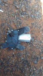 Used rear wiper motor assembly positioned to show mounting points and electrical connector side.Used rear wipe