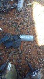 Rear view of used Vito 115 rear wiper motor with attached wiring and mounting bracket visible.Rear view of use
