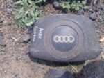 Front view of a used Audi A4 steering airbag assembly showing the airbag module and connector.Front view of a
