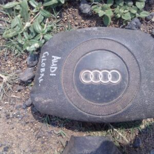 Front view of a used Audi A4 steering airbag assembly showing the airbag module and connector.Front view of a