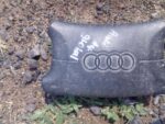 Front view of a used steering airbag module for Audi A4, displayed flat on a plain background.Front view of a