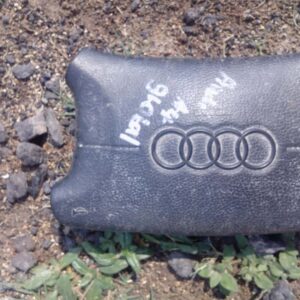 Front view of a used steering airbag module for Audi A4, displayed flat on a plain background.Front view of a