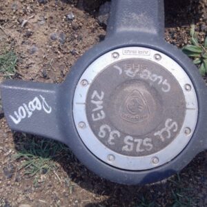 Front-facing view of a used steering wheel airbag module for a Proton Satria, showing central housing and conn