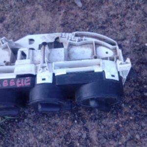 Front view of used Volkswagen Beetle climate control unit with dials and switches visible.Front view of used V