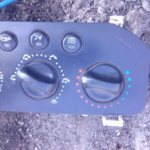 Front view of a used Renault climate control panel with buttons and display on a black frameFront view of a us