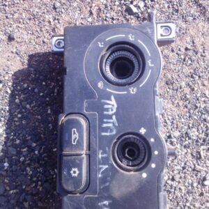 Front view of a used Tata Indica climate control unit with buttons and dials visible.Front view of a used Tata