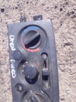 Front view of used climate control panel for Chevrolet Aveo with visible buttons and display screen.Front view