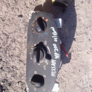 Climate control unit for Nissan NP200 shown from front, used condition visible in clean setup.Climate control