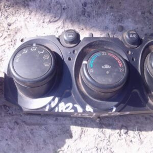 Front view of used Mazda 2 climate control panel featuring knobs and buttons for temperature and airflow setti