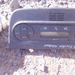 Front view of a used car climate control panel with digital display and buttons for temperature settings.Front