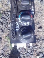Front view of used climate control unit for Mercedes Benz A160 showing buttons and display.Front view of used