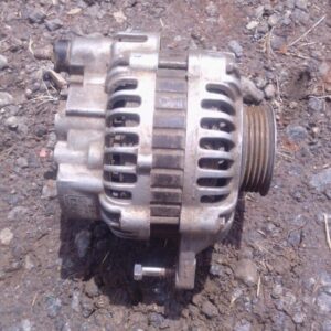 Front view of a used alternator for a Mitsubishi Colt showing mounting points and pulley.Front view of a used