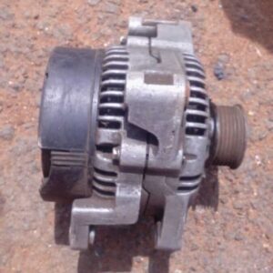 Front angled view of a used alternator for Volvo V90 showing mounting points and electrical connectors.Front a