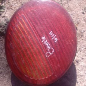 Used left taillight for Volkswagen Beetle shown from the rear angle with wiring harness attached.Used left tai