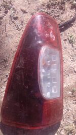 Used left taillight for Isuzu KB viewed from the rear side, showing lens and mounting points.Used left taillig