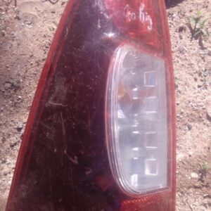 Used left taillight for Isuzu KB viewed from the rear side, showing lens and mounting points.Used left taillig