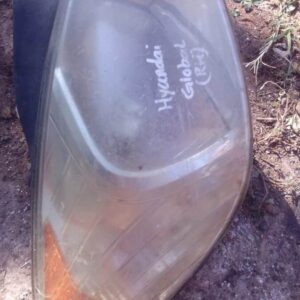 Right front headlight for Hyundai Accent, used condition, shown from front angle on white background.Right fro