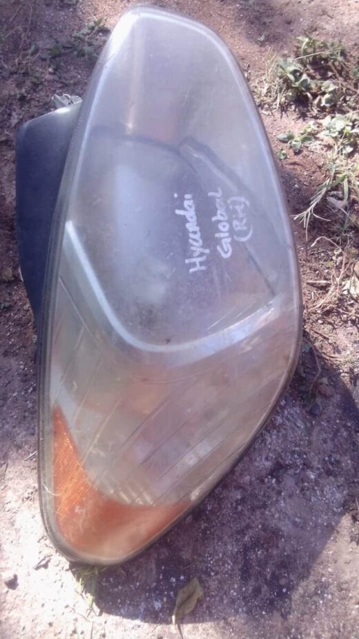 2006 Hyundai Accent Right Headlight - Used Right front headlight for Hyundai Accent, used condition, shown from front angle on white background.Right fro