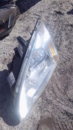 Left headlight for Ford Focus, showing front and side view, used condition.Left headlight for Ford Focus, show