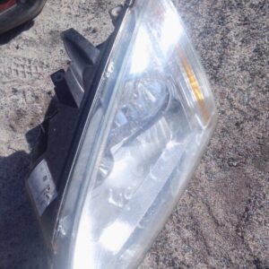Left headlight for Ford Focus, showing front and side view, used condition.Left headlight for Ford Focus, show