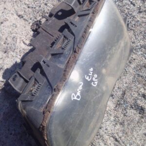 Left front headlight for BMW E46, angled slightly to show front and side, used condition.Left front headlight