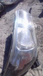 Right headlight assembly for Toyota Hilux, shown from front angle, in used condition.Right headlight assembly