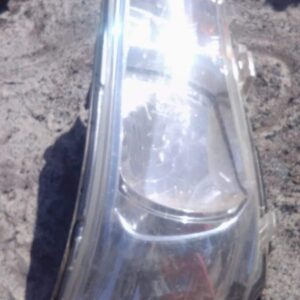 Right headlight assembly for Toyota Hilux, shown from front angle, in used condition.Right headlight assembly