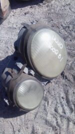 Front-facing left headlight assembly for Mercedes Benz W210, used condition, clean lens and wiring visible.Fro