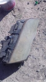 Right front headlight for BMW E46, used condition, shown from front angle.Right front headlight for BMW E46, u