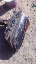 Left side BMW E46 headlight viewed from front angle, used condition with clear lens and housing visible.Left s