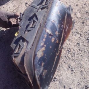 Left side BMW E46 headlight viewed from front angle, used condition with clear lens and housing visible.Left s