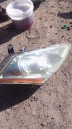 Right side headlight for Nissan Murano, used condition, shown from front angle.Right side headlight for Nissan