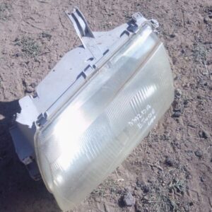 Right side used headlight for 2002 Mazda Etude shown from front angle on white background.Right side used head