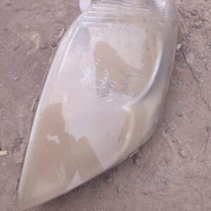 Right-side used headlight for Toyota Corolla, angled clear lens with black housing visible.Right-side used hea