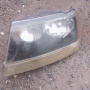 Left side used headlight assembly for Jeep Grand Cherokee shown from a front angle.Left side used headlight as
