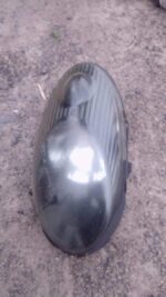 Used left headlight assembly for a 2007 Nissan Micra, angled left side view, clean with minor wear.Used left h