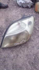 Left side used headlight for a Renault Scenic, showing front and side lens and connector details.Left side use