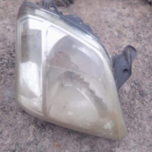 Used right headlight for Isuzu KB shown from front angle, highlighting headlamp lens and casing.Used right hea