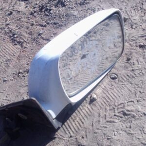 Right side exterior mirror for Subaru Outback, used condition, angled facing left on white background.Right si