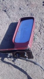 Used right side exterior mirror for Ford Sierra shown angled from the rear side with mounting bracket.Used rig