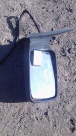 Right side exterior mirror for a 1994 Ford Sapphire, shown used, angled slightly downward against a white back