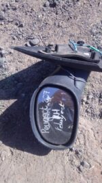 Left side exterior mirror for Peugeot 207, used condition, shown angled from front left side.Left side exterio