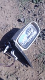 Used left side mirror for 2006 Ford Bantam shown from front angle on white background.Used left side mirror fo